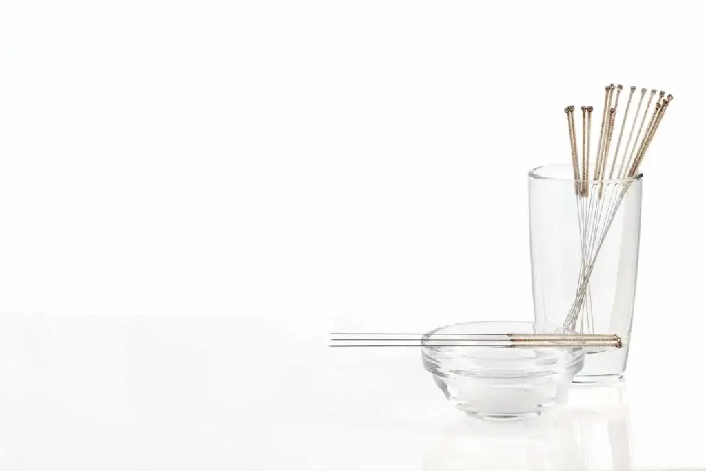 traditional Chinese acupuncture needles in a glass container